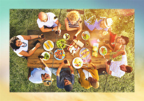 Overhead view of neighbors enjoying an outdoor meal together