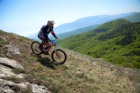 Mountain biker going down a mountain slope